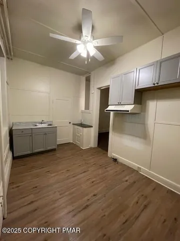 a view of a kitchen with wooden floor