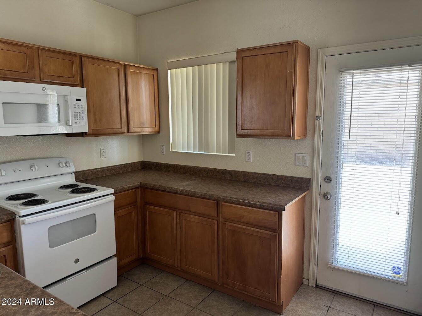 9401 West Berkeley Road Phoenix, AZ 85037 - Photo 5 of 27 a kitchen with cabinets appliances and a window