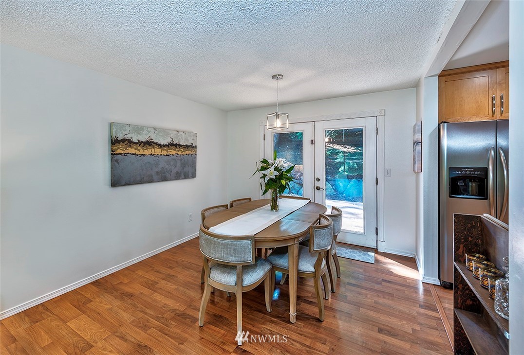 23002 Atlas Road Bothell, WA 98021 - Photo 10 of 23 a view of a dining room with furniture window and wooden floor