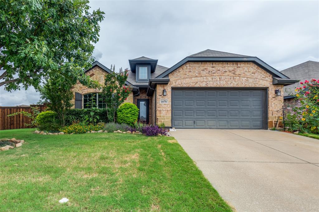 2076 Leonard Ranch Road Fort Worth, TX 76134 - Photo 1 of 1 View of front facade with a garage and a front lawn