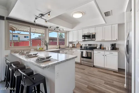 a kitchen with a stove a sink and a refrigerator