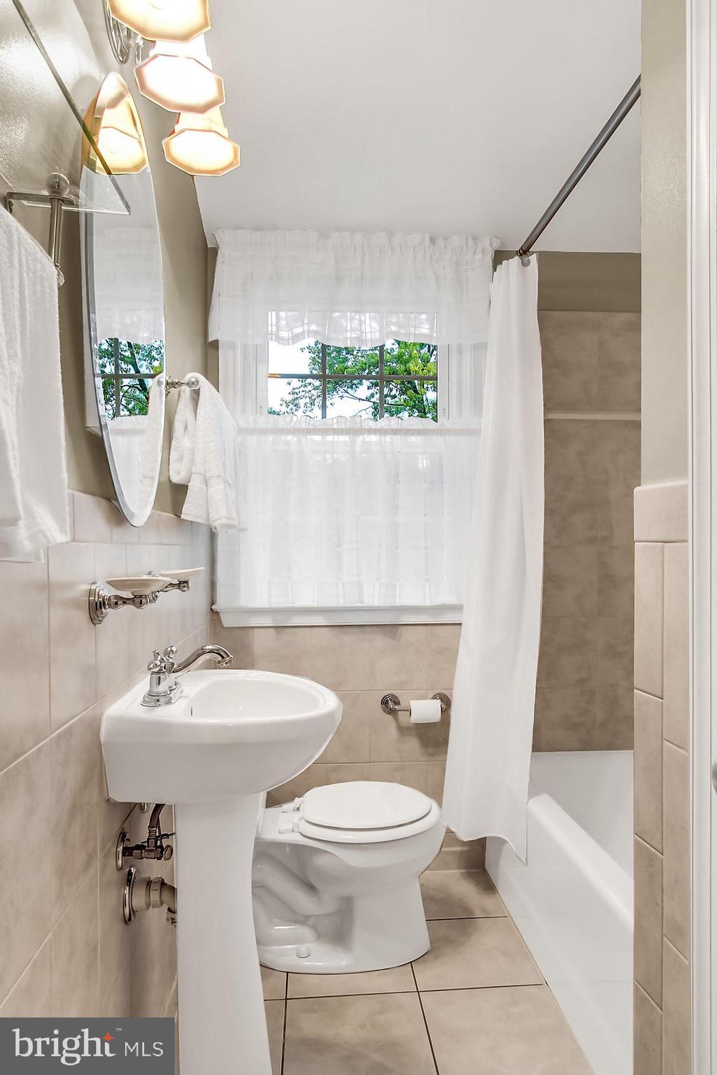 1629 Hardwick Road Baltimore, MD 21286 - Photo 13 of 22 Updated hall bath - white & neutral tile work