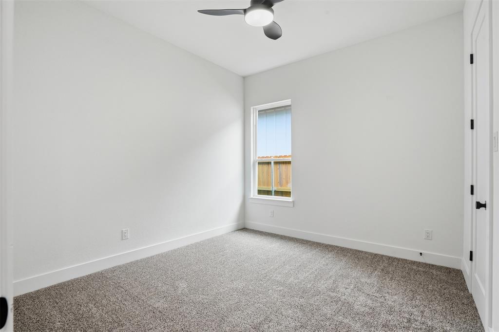 1111 Riverwood Road Dallas, TX 75217 - Photo 35 of 40 Neutral wall tones paired with textured carpeting