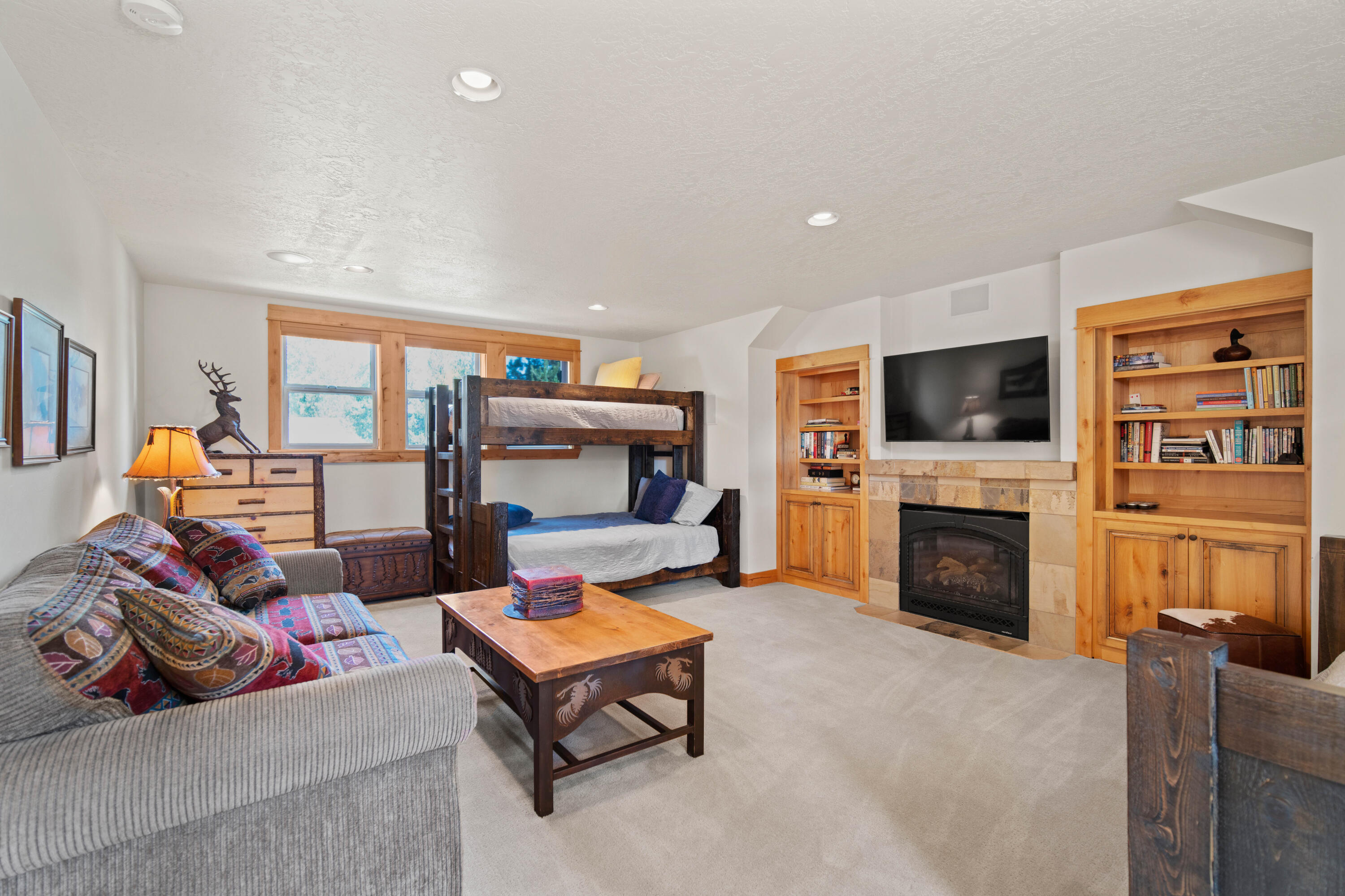 56689 Dancing Rock Loop Bend, OR 97707 - Photo 33 of 51 a living room with furniture fireplace and flat screen tv