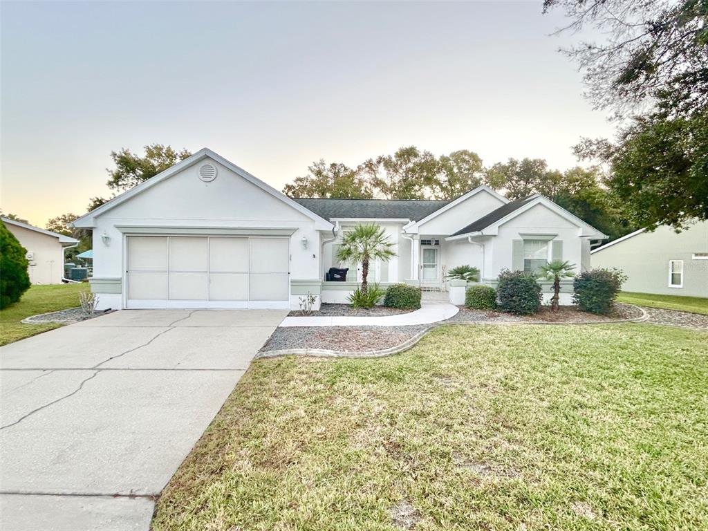 a front door view of a house with a yard and garage