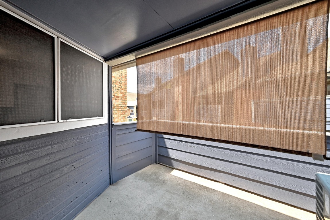 2500 Burleson Road, Unit 311 Austin, TX 78741 - Photo 13 of 16 a view of room with window and wooden floor