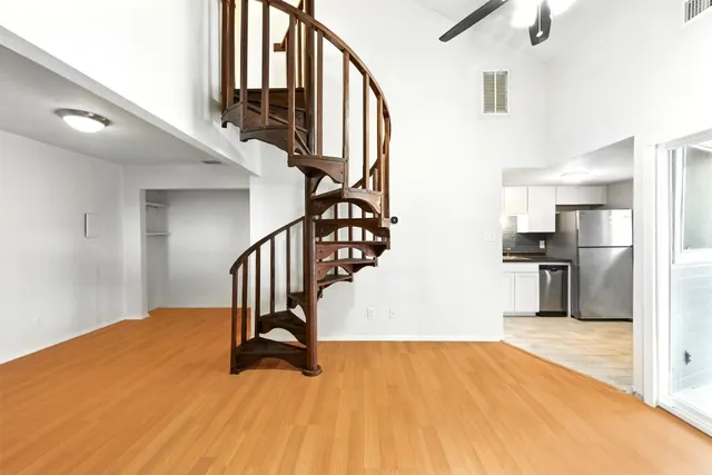 a kitchen that has a sink stainless steel appliances and cabinets