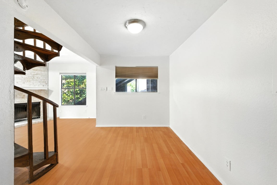 2500 Burleson Road, Unit 311 Austin, TX 78741 - Photo 5 of 16 wooden floor in an empty room with a window