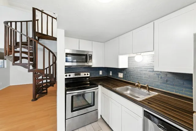 a kitchen with a refrigerator and a sink