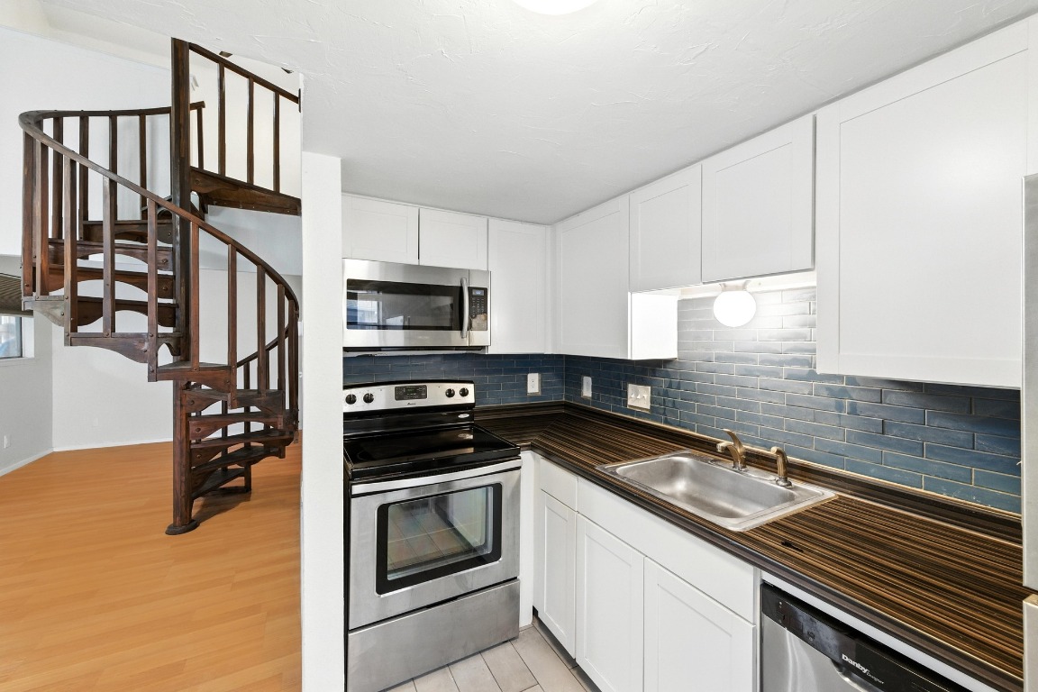 2500 Burleson Road, Unit 311 Austin, TX 78741 - Photo 6 of 16 a kitchen that has a sink stainless steel appliances and cabinets