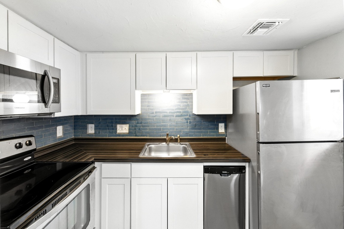2500 Burleson Road, Unit 311 Austin, TX 78741 - Photo 8 of 16 a kitchen with a refrigerator and a sink