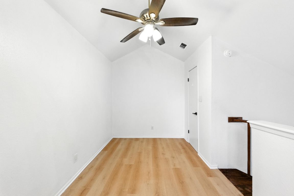 2500 Burleson Road, Unit 311 Austin, TX 78741 - Photo 10 of 16 a view of a room with wooden floor and a ceiling fan