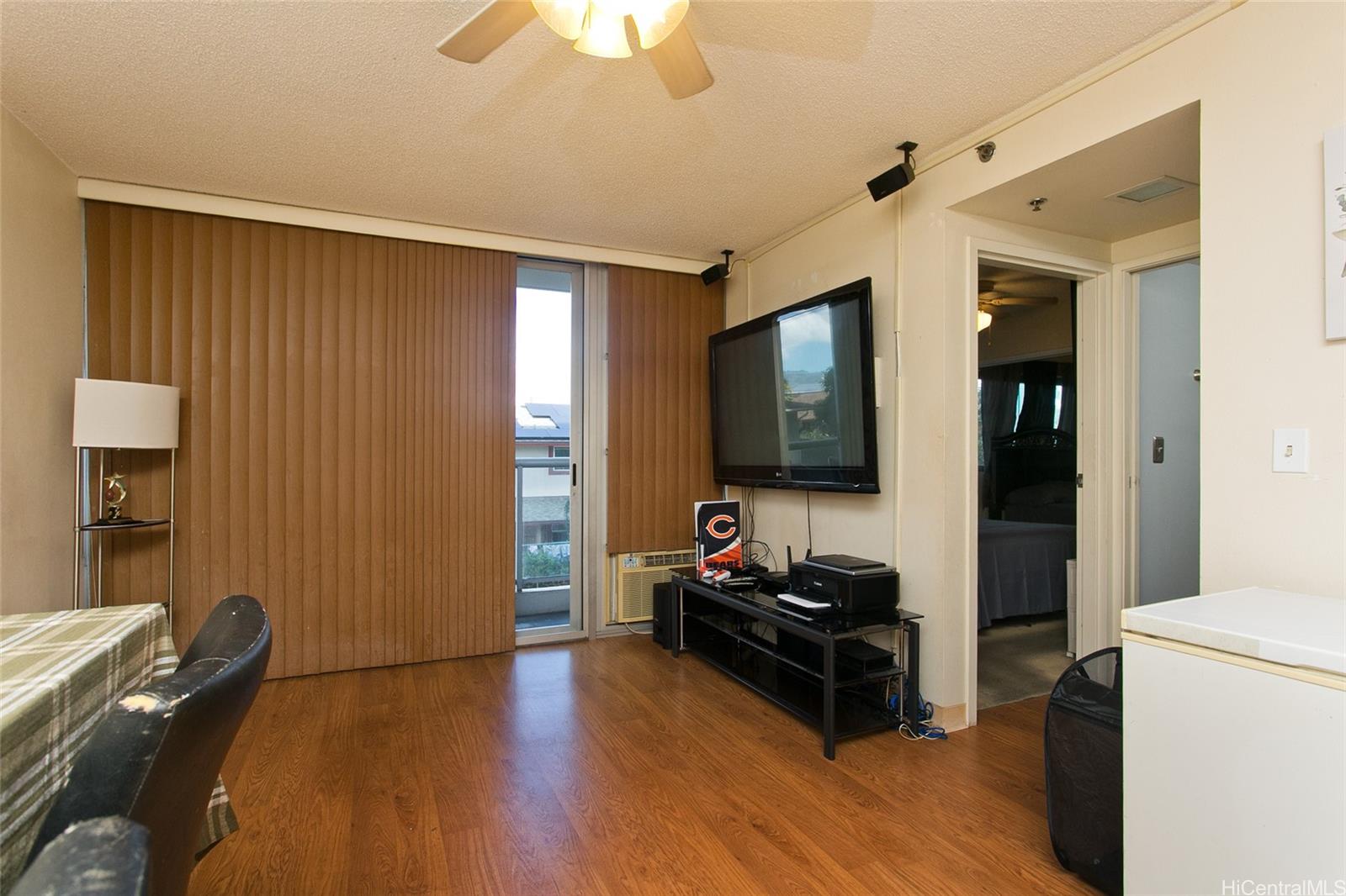 94-302 Paiwa Street, Unit 202 Waipahu, HI 96797 - Photo 3 of 12 a living room with furniture and a flat screen tv