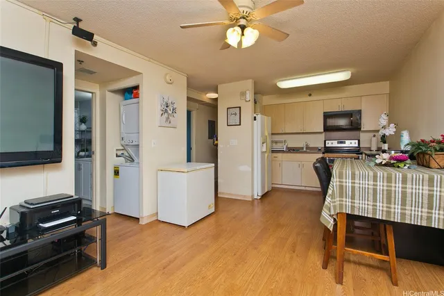 a kitchen with stainless steel appliances kitchen island granite countertop a refrigerator and a stove top oven