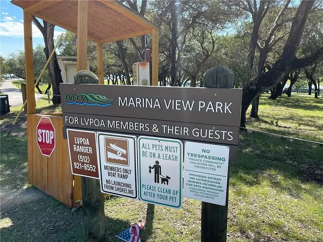 a view of a street sign under a large tree
