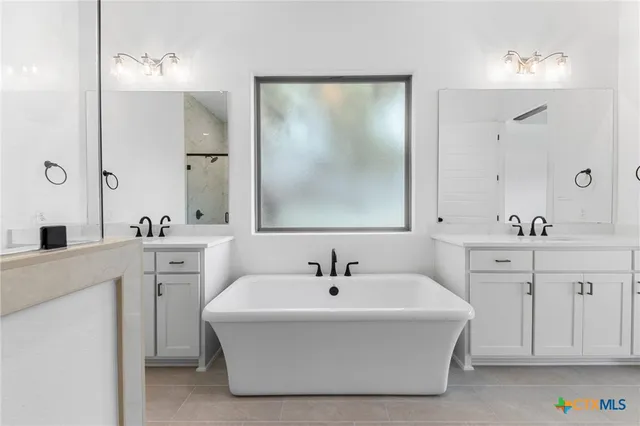 a white bath tub sitting next to a bathroom sink