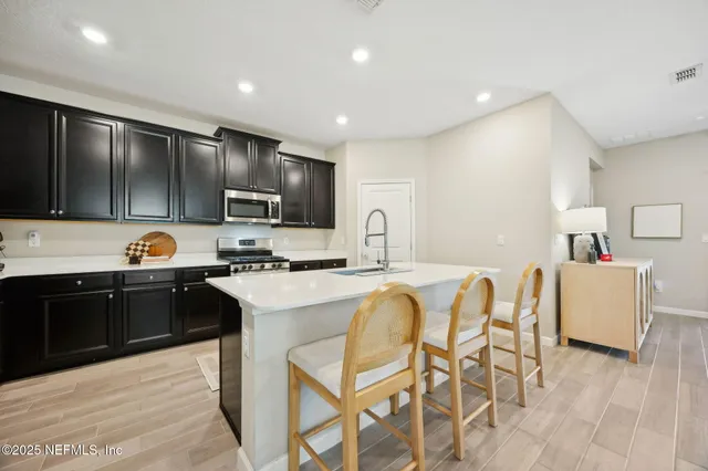 a kitchen with cabinets a sink and appliances
