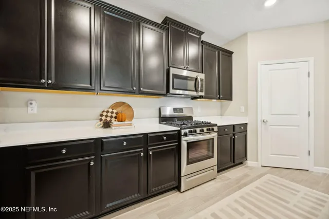 a kitchen with granite countertop stainless steel appliances and sink