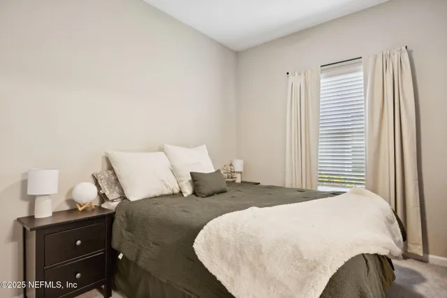 a bedroom with a bed and lamp