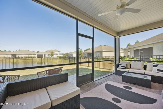 a living room with furniture and a floor to ceiling window