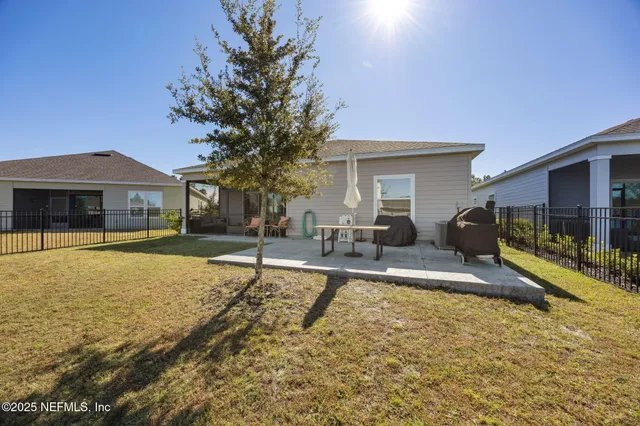 a view of house with yard and swimming pool