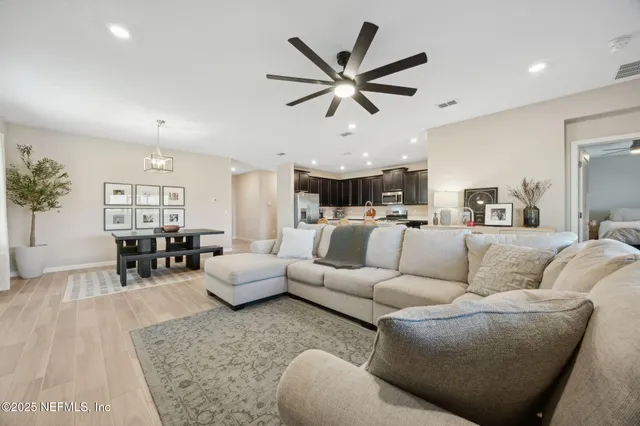 a living room with furniture and view of kitchen