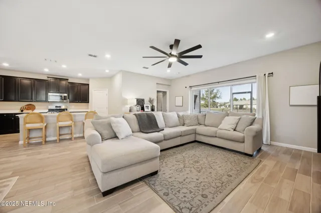 a living room with furniture and view of kitchen