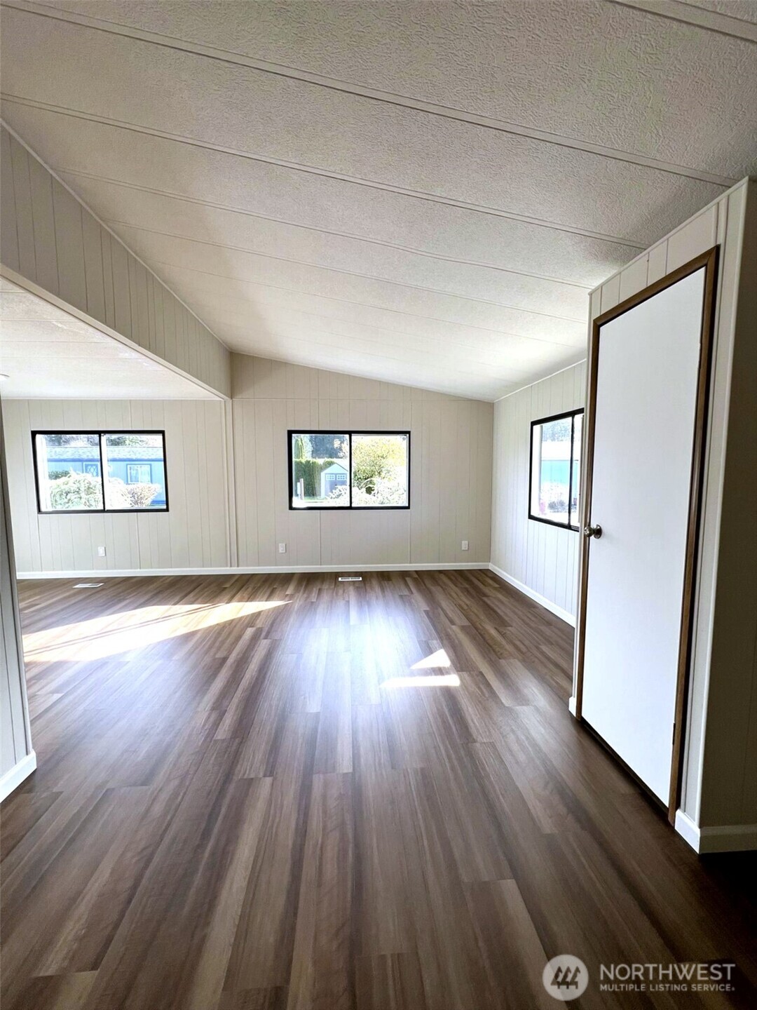 9900 Blomberg Street Southwest, Unit 8 Olympia, WA 98512 - Photo 2 of 8 an empty room with wooden floor and windows