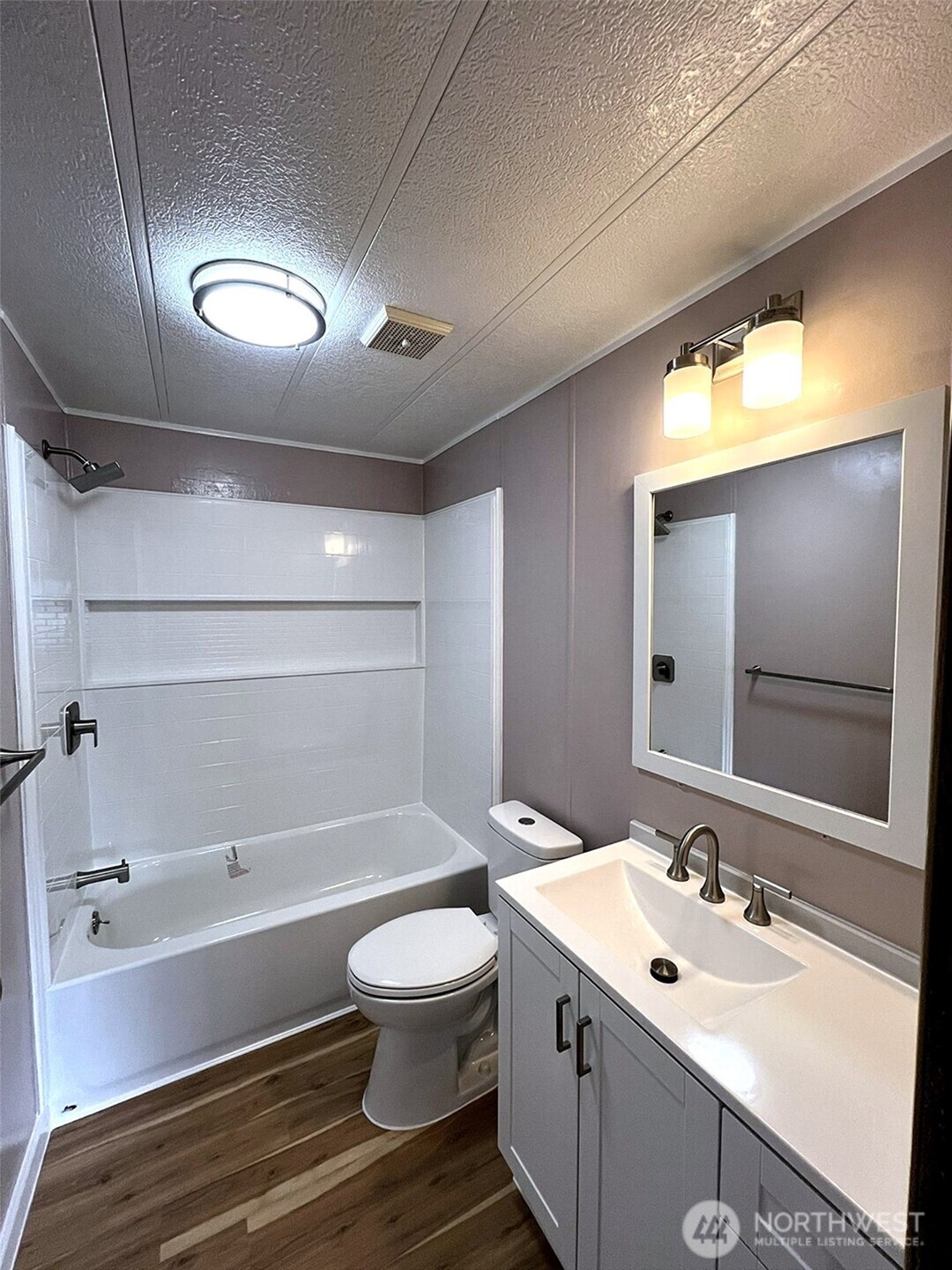 9900 Blomberg Street Southwest, Unit 8 Olympia, WA 98512 - Photo 5 of 8 a bathroom with a sink and mirror with toilet