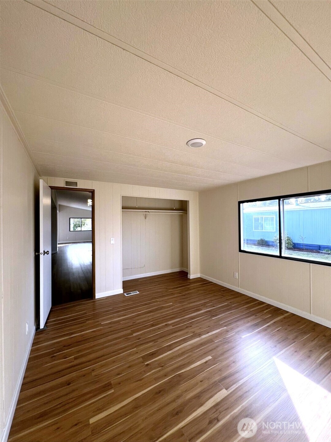 9900 Blomberg Street Southwest, Unit 8 Olympia, WA 98512 - Photo 7 of 8 a view of an empty room with window and wooden floor