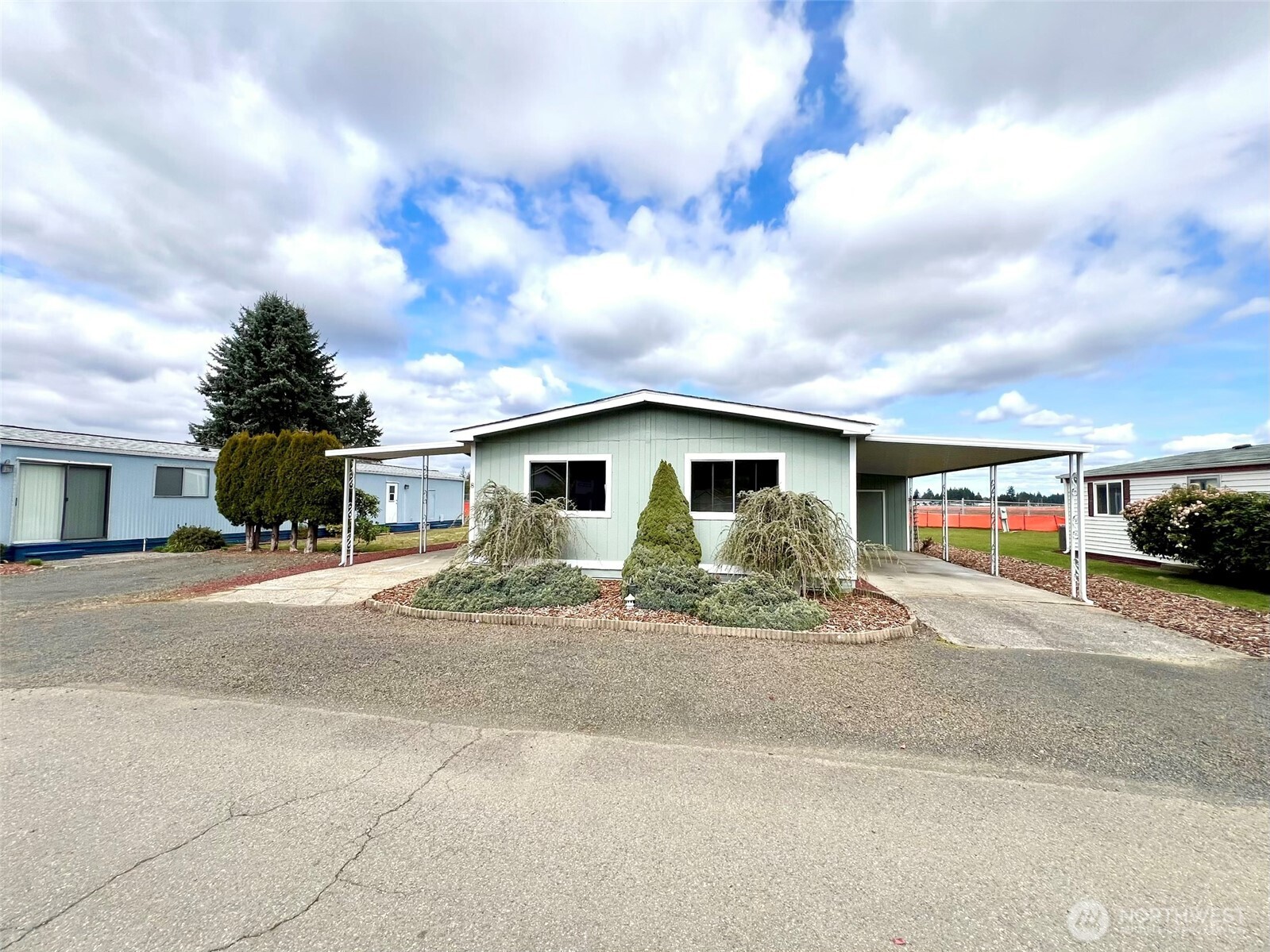 9900 Blomberg Street Southwest, Unit 8 Olympia, WA 98512 - Photo 8 of 8 a front view of a house with a yard and garage