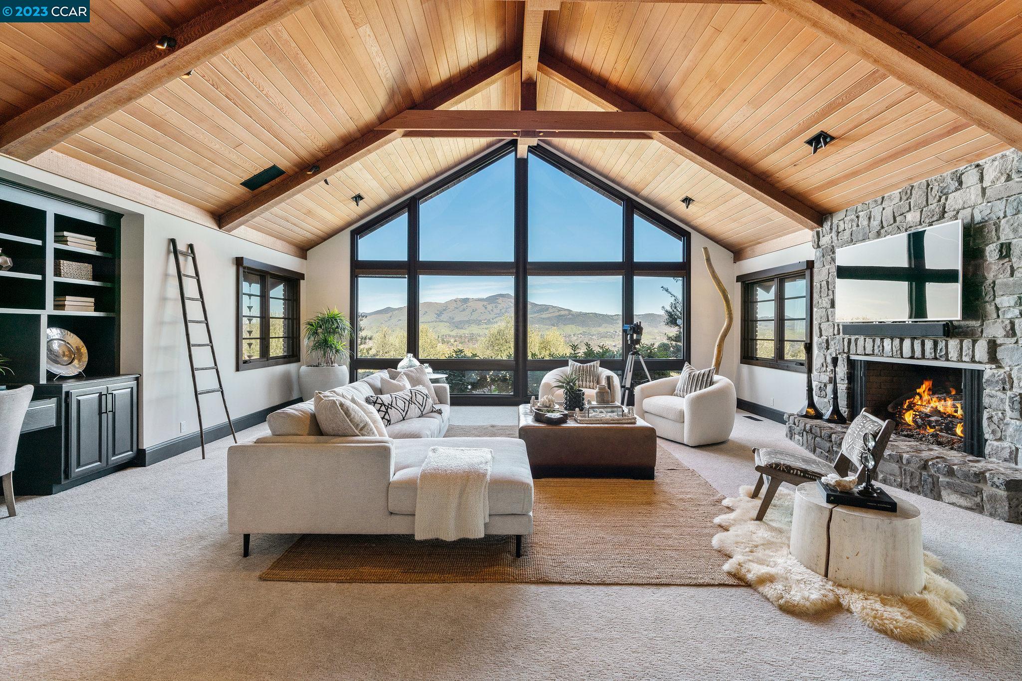 a living room with furniture and a floor to ceiling window
