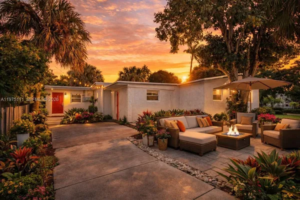 a view of a patio with furniture and a fire pit