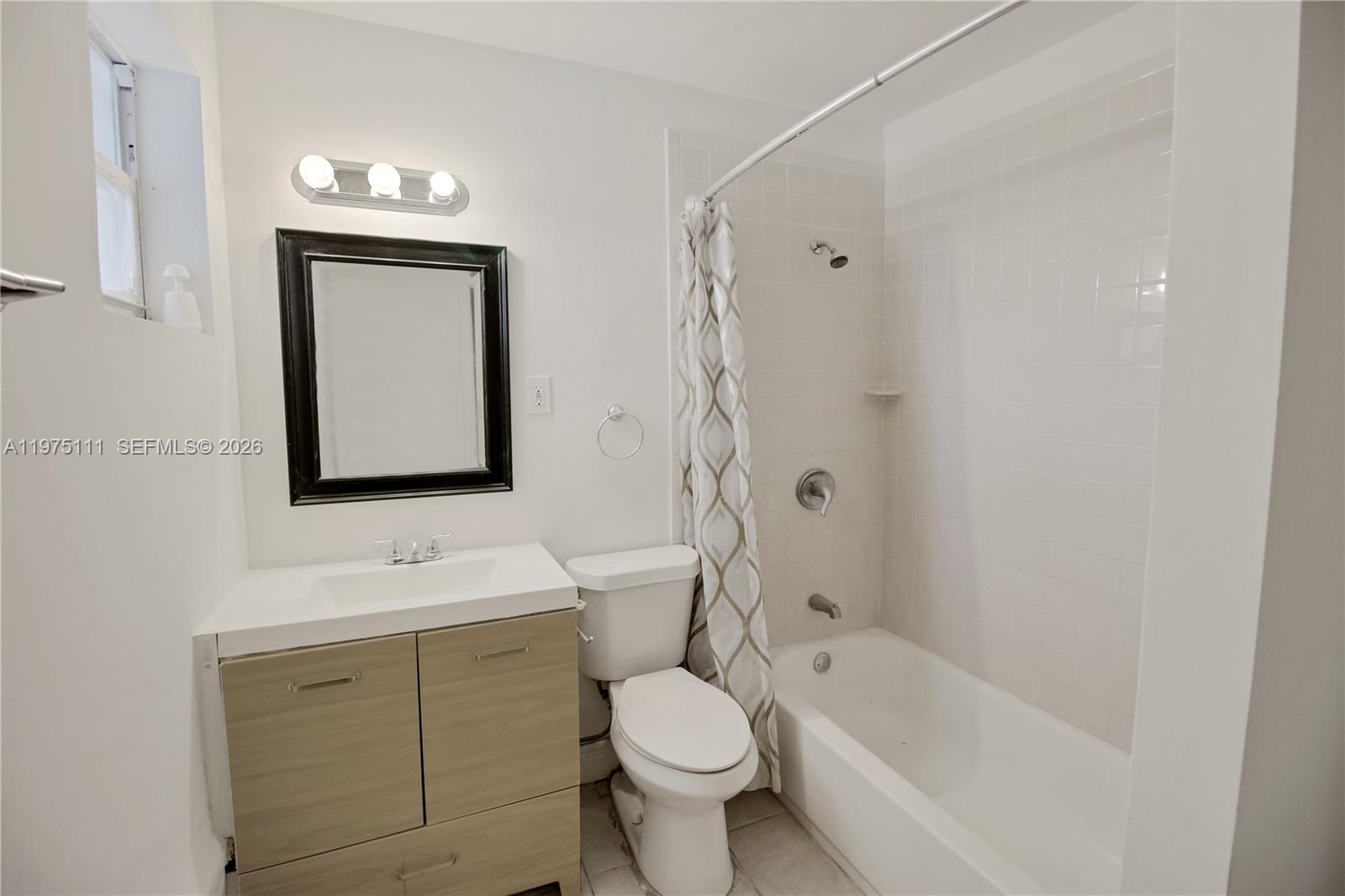 1160 West 26th Court Riviera Beach, FL 33404 - Photo 11 of 39 a bathroom with a toilet sink and mirror