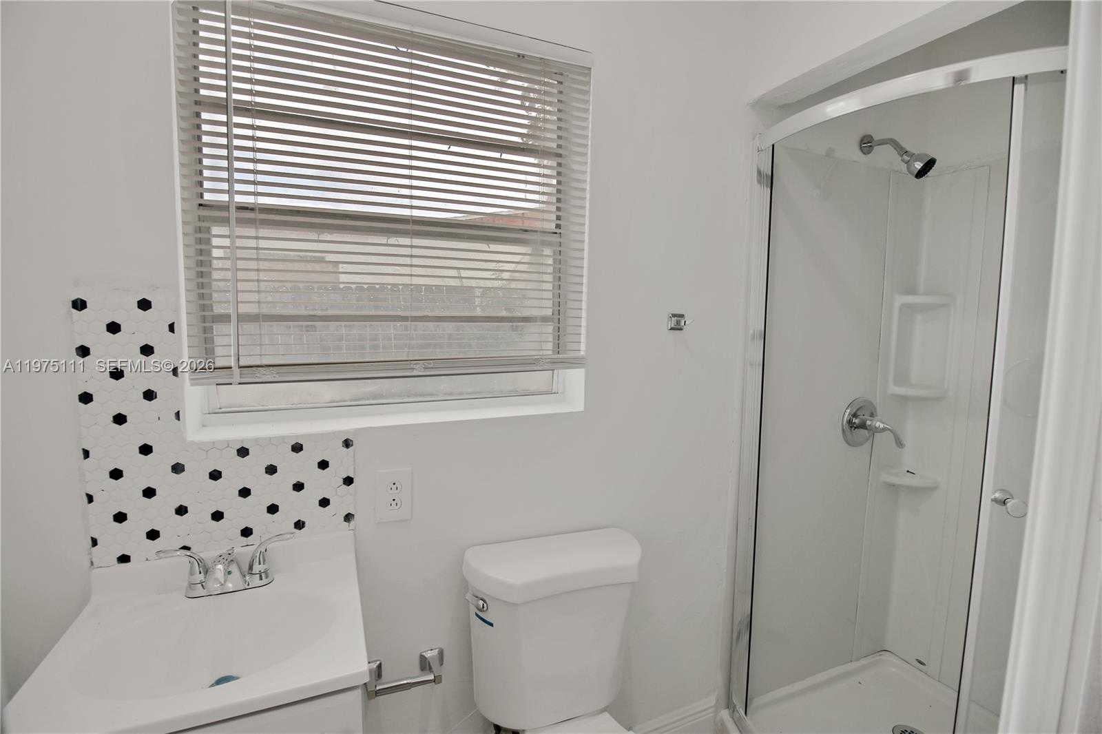 1160 West 26th Court Riviera Beach, FL 33404 - Photo 25 of 40 a bathroom with a sink a toilet and shower