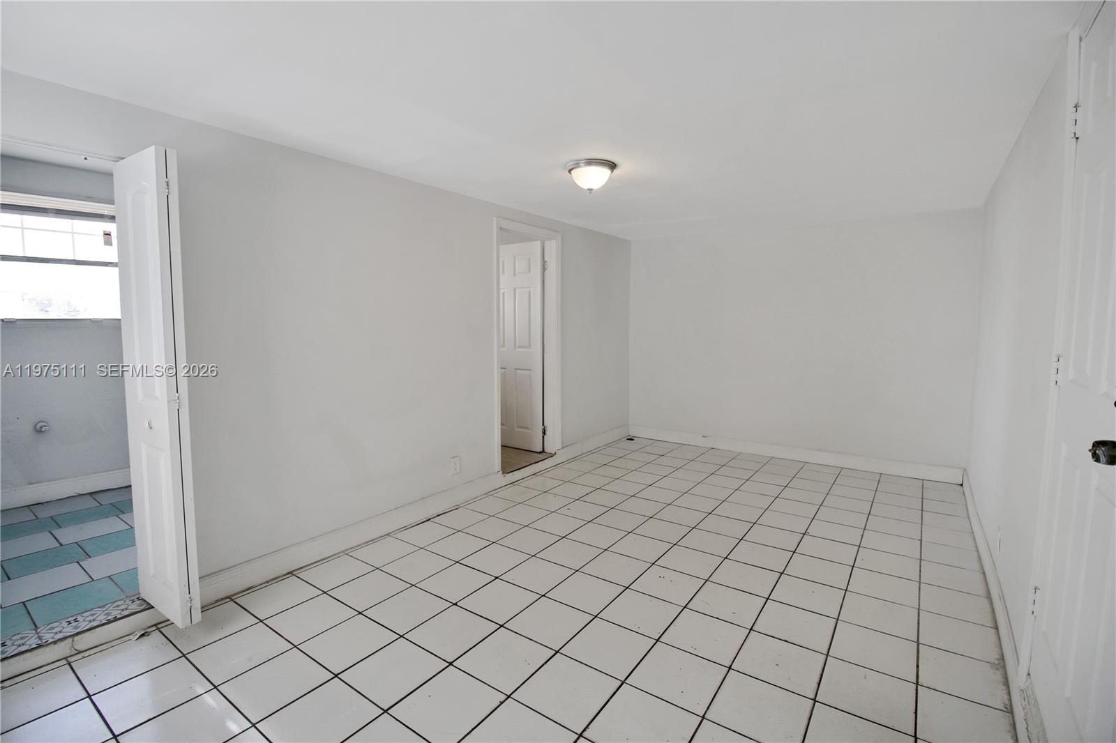 1160 West 26th Court Riviera Beach, FL 33404 - Photo 27 of 40 a view of an empty room and window