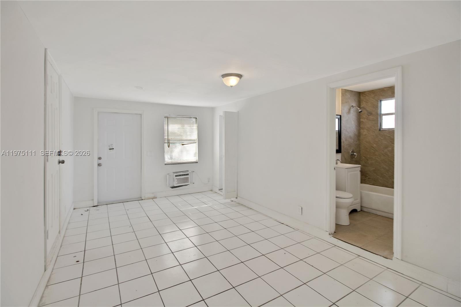 1160 West 26th Court Riviera Beach, FL 33404 - Photo 29 of 40 a view of a room with window and bathroom