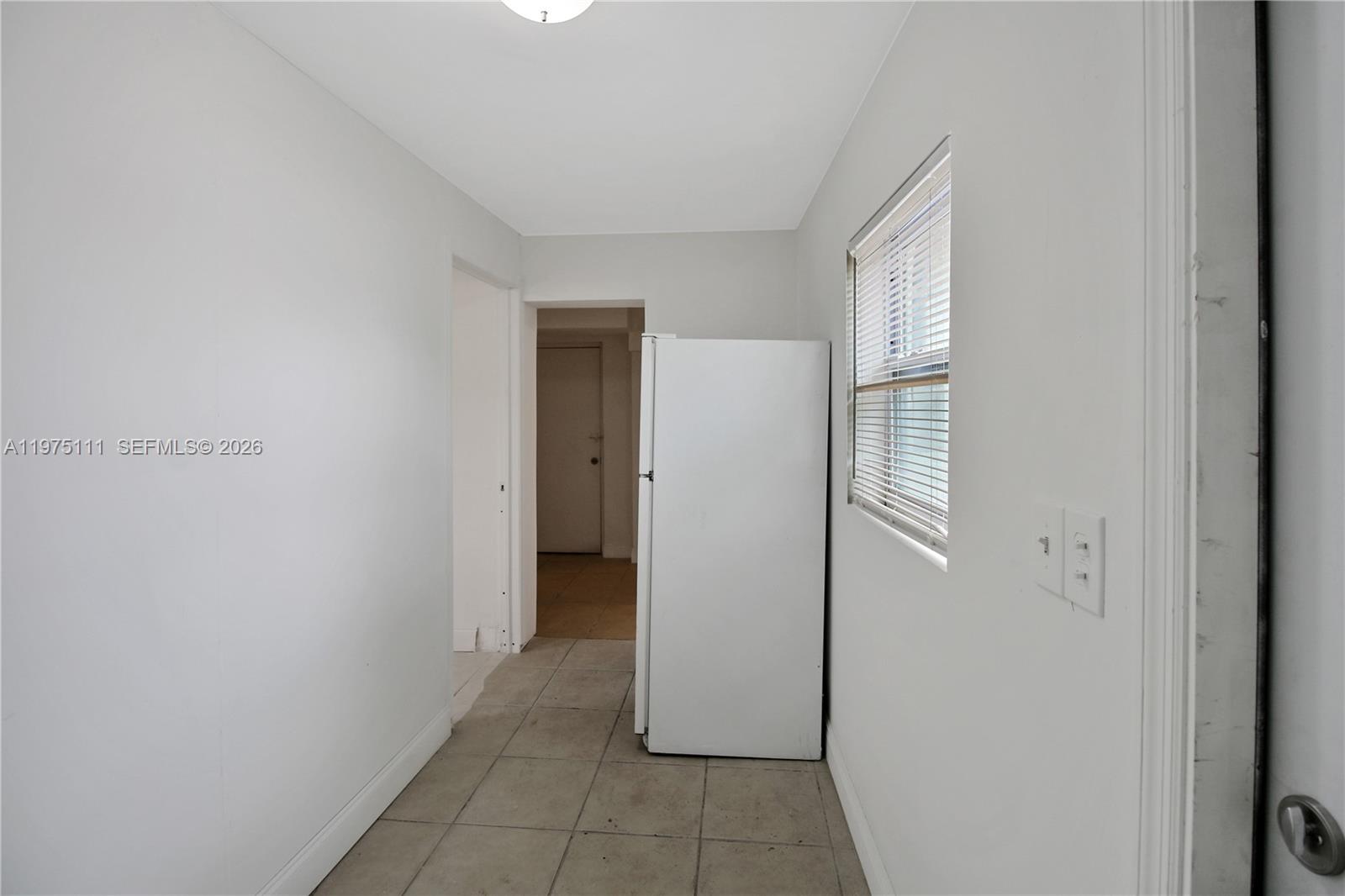 1160 West 26th Court Riviera Beach, FL 33404 - Photo 3 of 40 a view of a closet area with living room