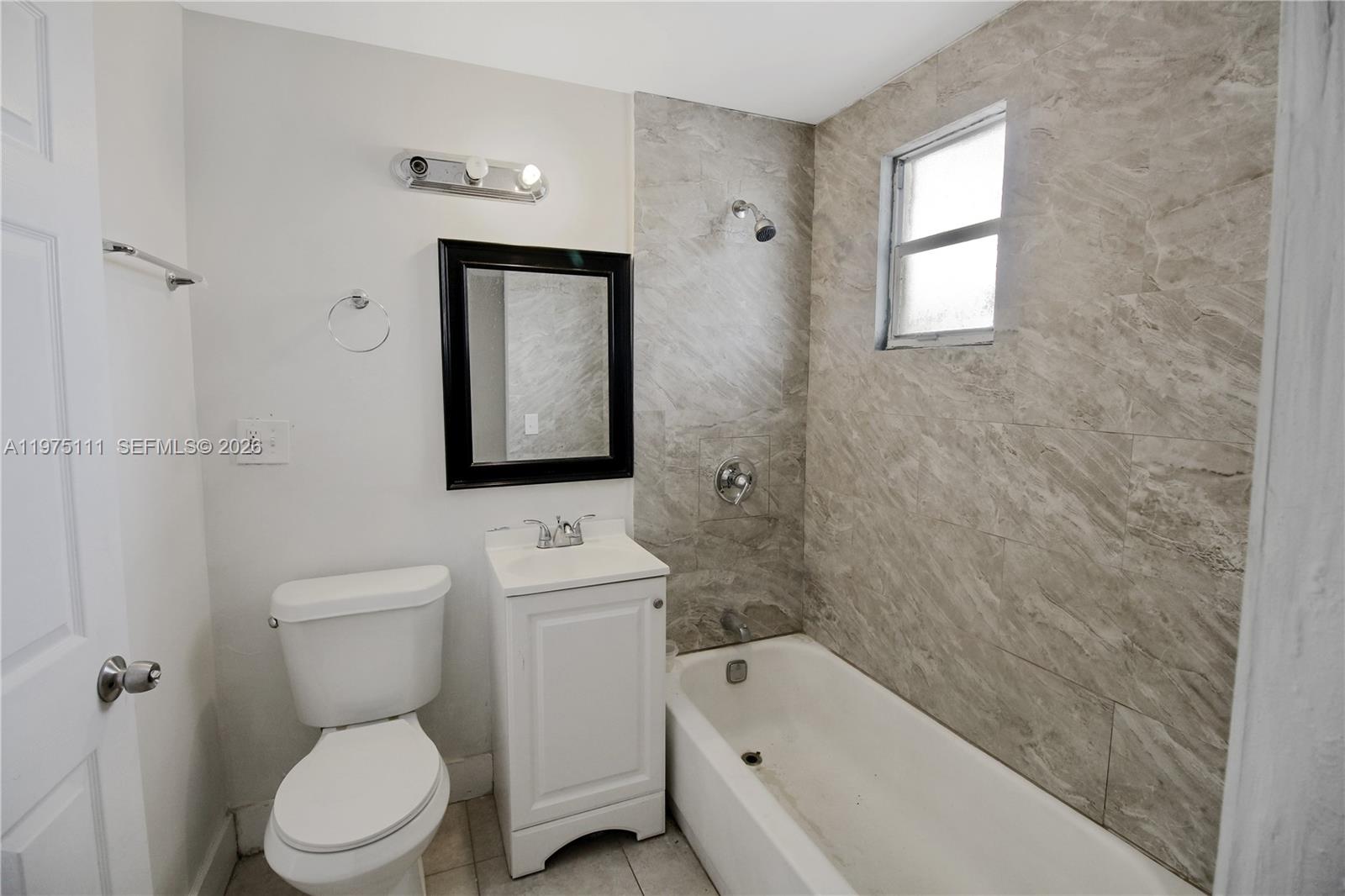 1160 West 26th Court Riviera Beach, FL 33404 - Photo 34 of 40 a bathroom with a toilet sink and bathtub
