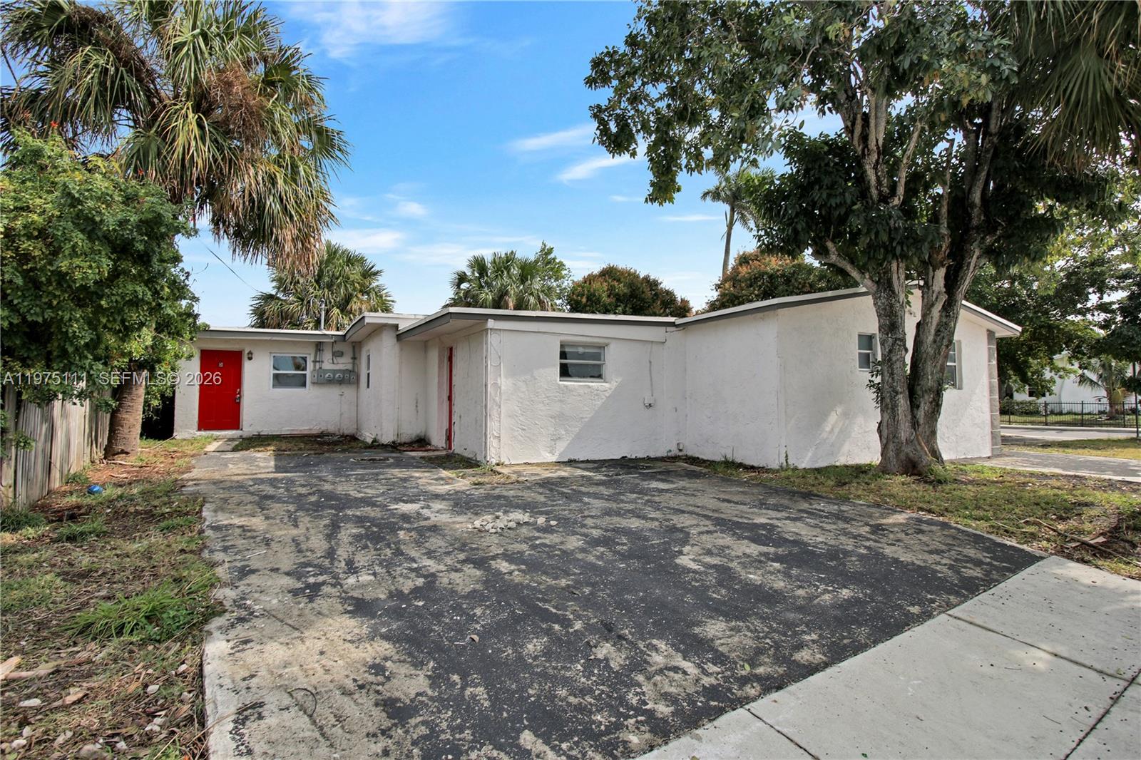 1160 West 26th Court Riviera Beach, FL 33404 - Photo 35 of 40 a view of a house with a yard and garage