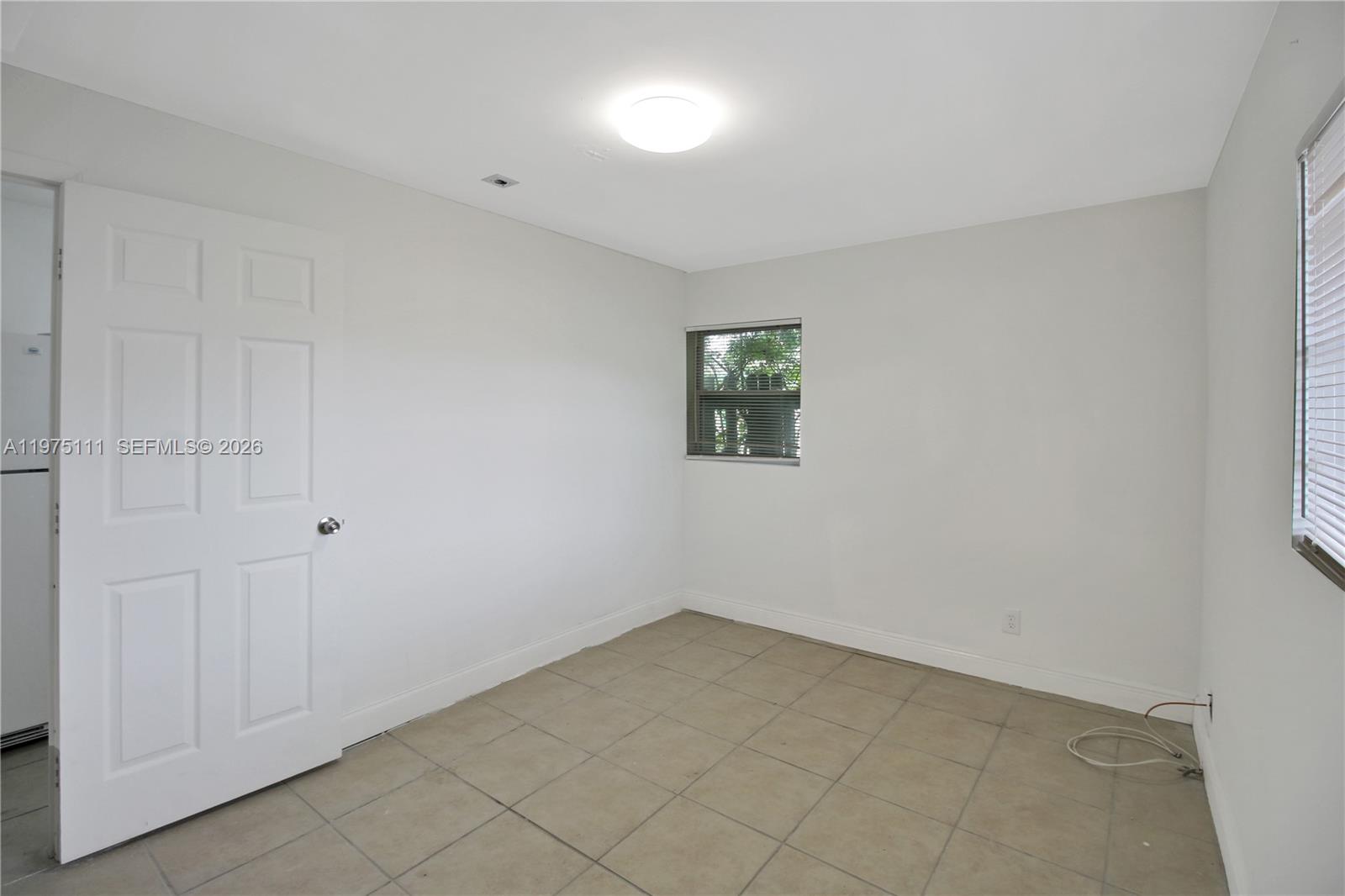 1160 West 26th Court Riviera Beach, FL 33404 - Photo 5 of 39 a view of an empty room and window