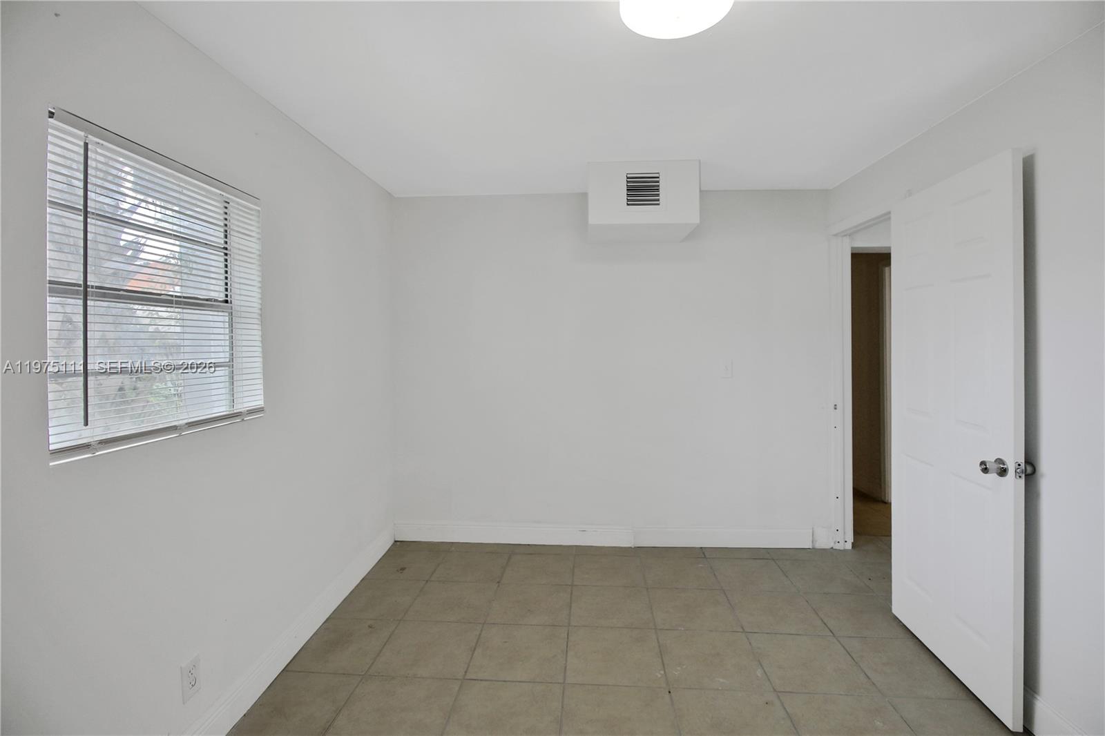 1160 West 26th Court Riviera Beach, FL 33404 - Photo 6 of 39 a view of an empty room with closet and window
