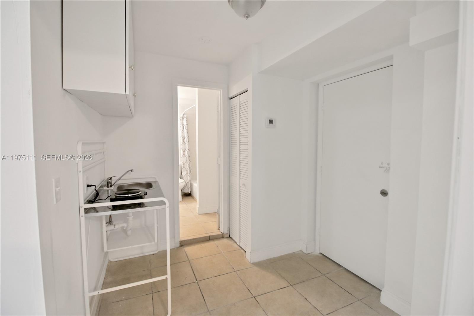 1160 West 26th Court Riviera Beach, FL 33404 - Photo 8 of 39 a kitchen with granite countertop a sink and cabinets