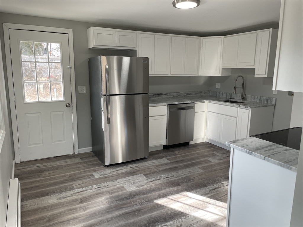 86 Fieldston Street Springfield, MA 01119 - Photo 5 of 17 a kitchen with a refrigerator sink and cabinets