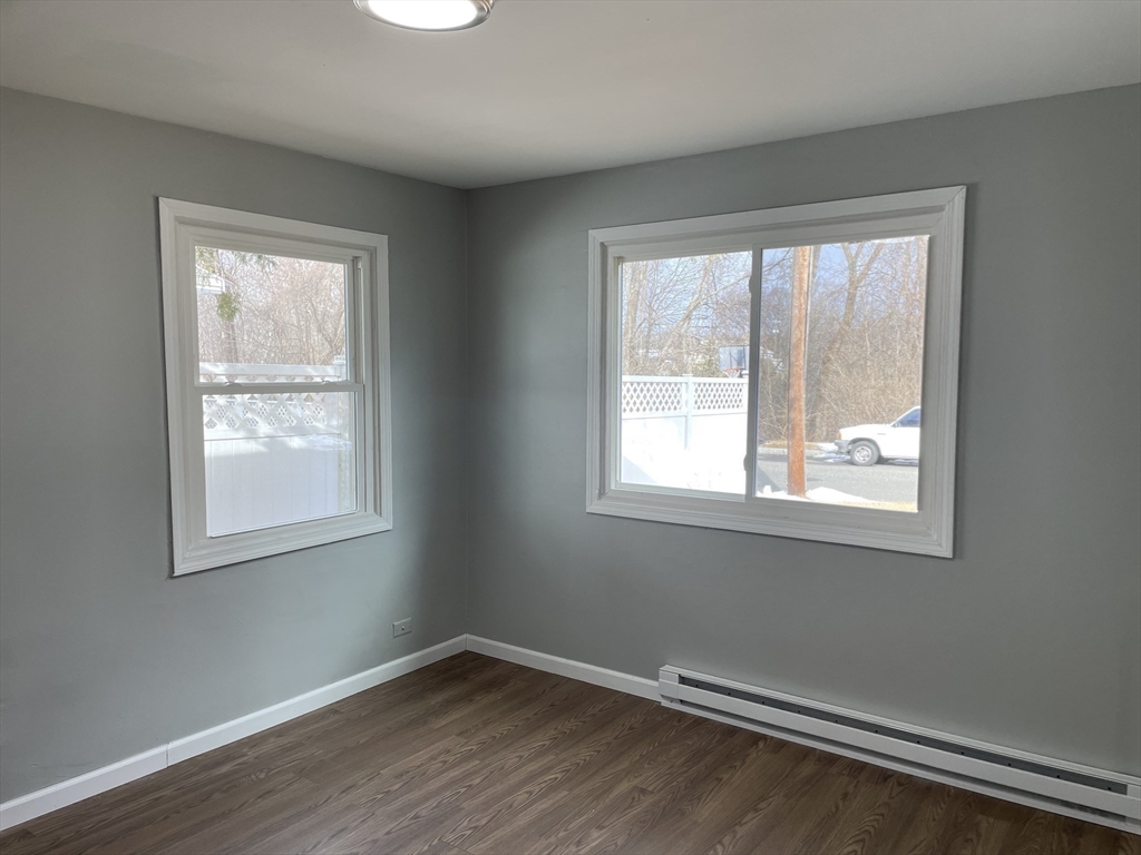 86 Fieldston Street Springfield, MA 01119 - Photo 8 of 17 a view of an empty room with wooden floor and a window