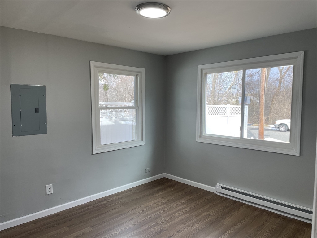 86 Fieldston Street Springfield, MA 01119 - Photo 9 of 17 a view of an empty room with wooden floor and a window