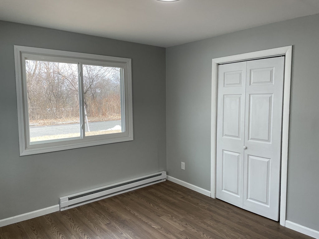 86 Fieldston Street Springfield, MA 01119 - Photo 10 of 17 an empty room with wooden floor and windows