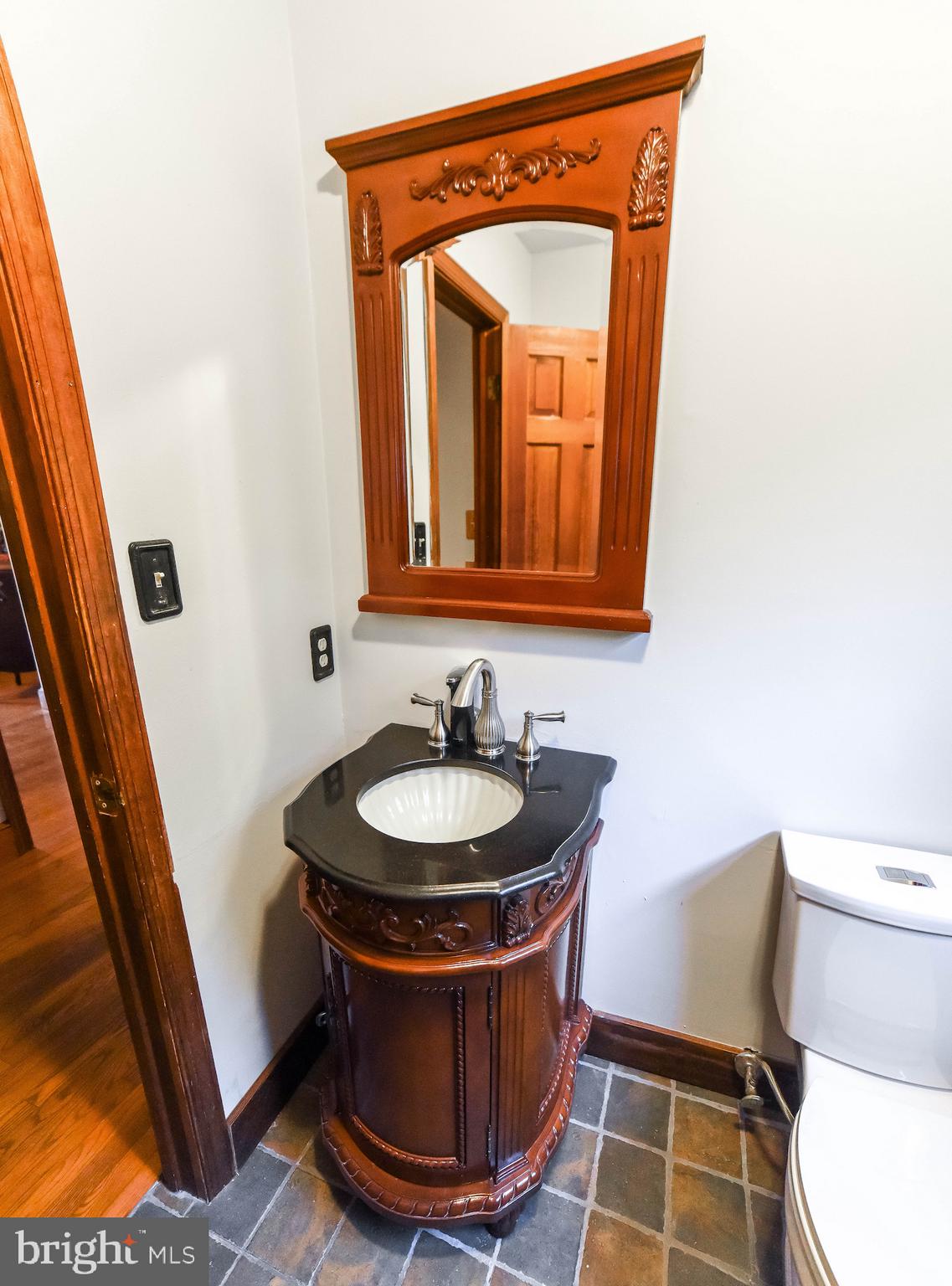 8445 Waverly Road Owings, MD 20736 - Photo 13 of 36 a room with a mirror and a sink