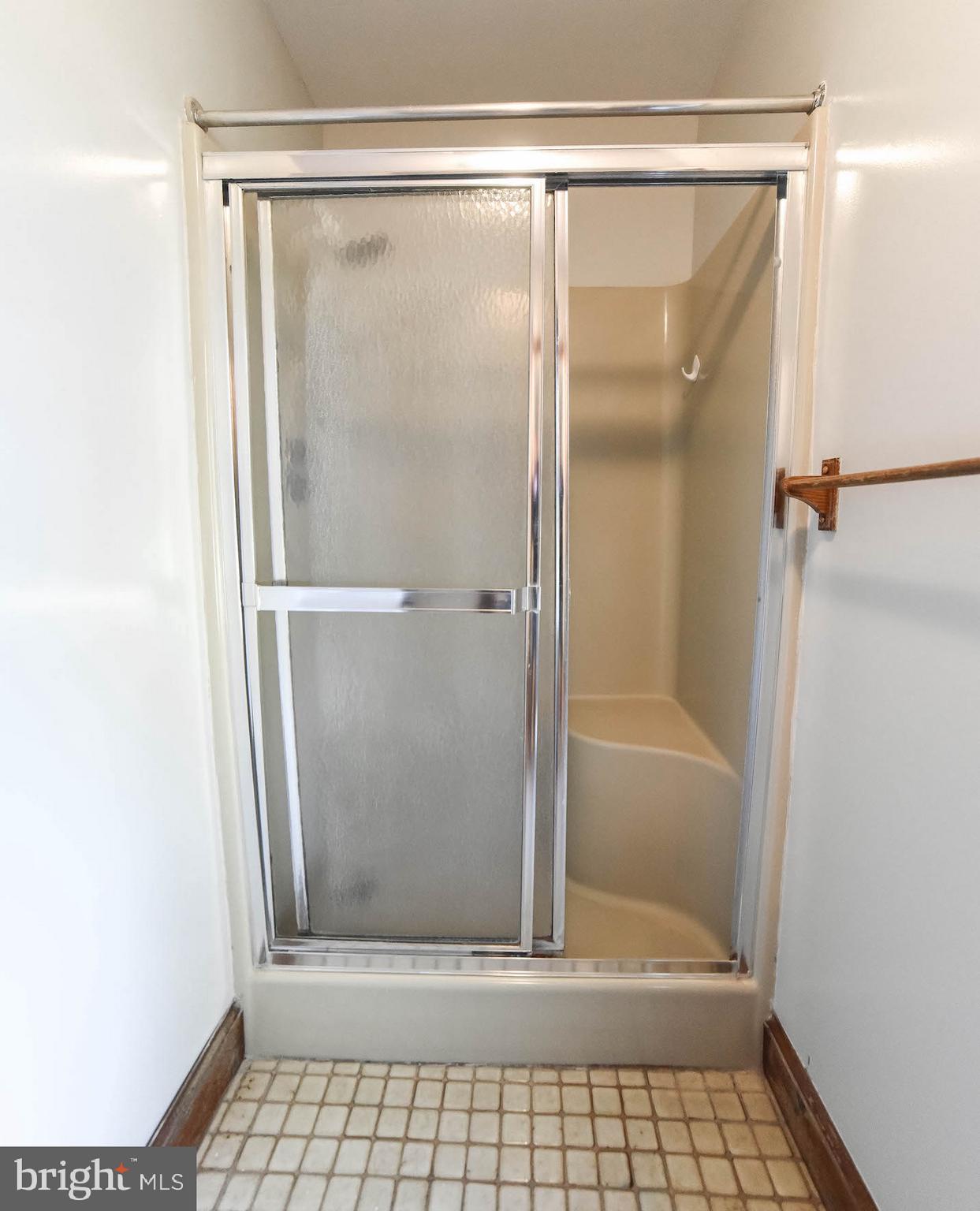 8445 Waverly Road Owings, MD 20736 - Photo 17 of 36 a bathroom with a glass shower door