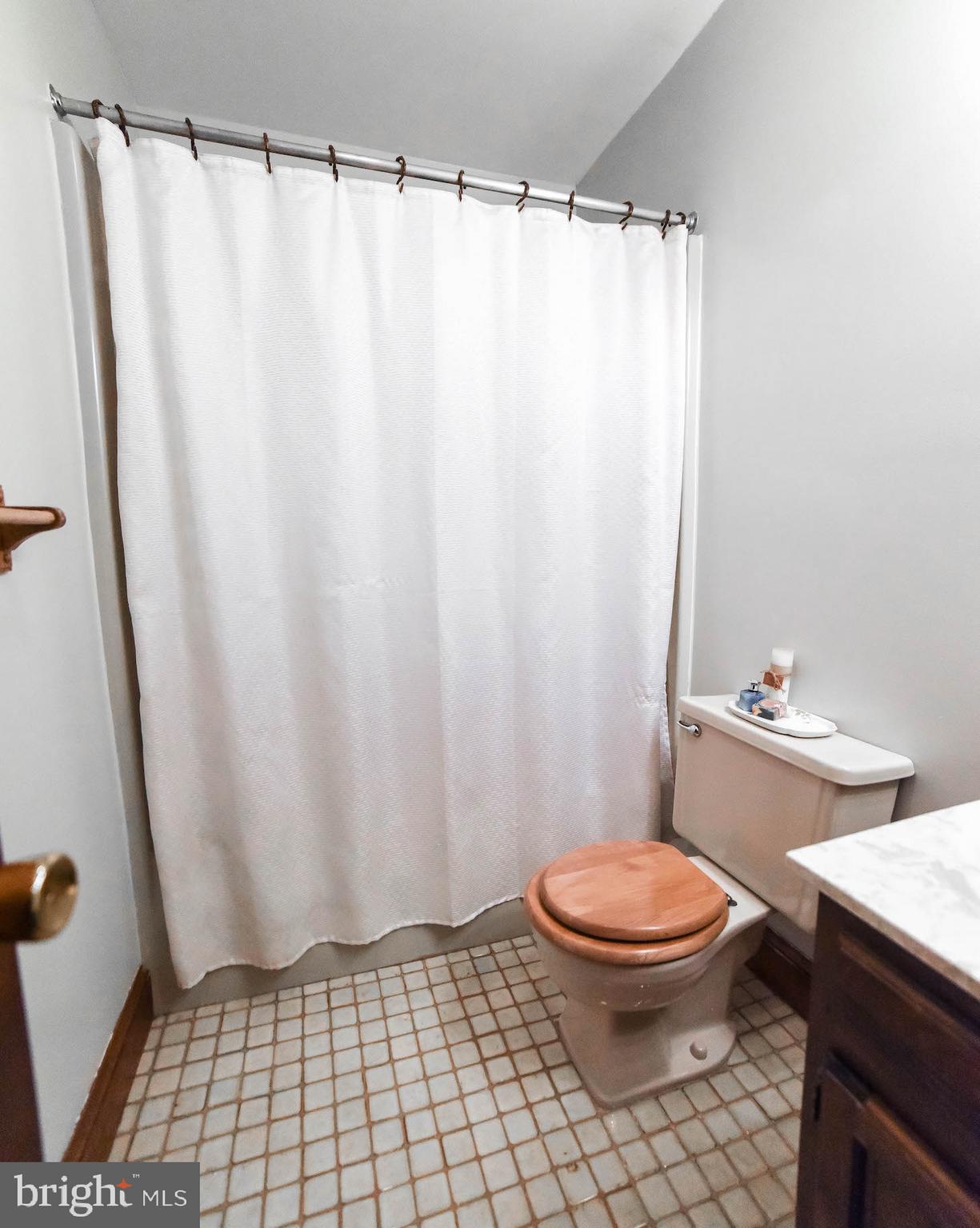 8445 Waverly Road Owings, MD 20736 - Photo 20 of 36 a bathroom with a toilet and a shower curtain